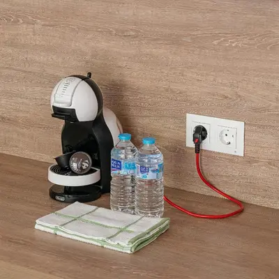 a hair dryer and two bottles of water plugged into an outlet at NEW DUPLEX, 2 WC, FRENTE CIUDAD DE LAS CIENCIAS Y LAS ARTES in Valencia
