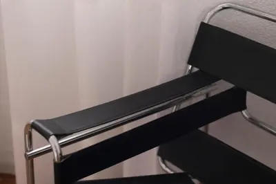 a close up of a black bench in a room at Comfortable and Elegant Seafront Apartment in Faro de Cullera