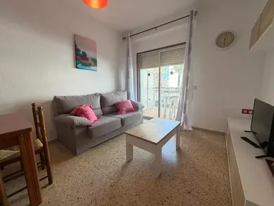 a living room with a couch and a table at Wimpy Solo Familias Serviplaya in Casas Las Basas