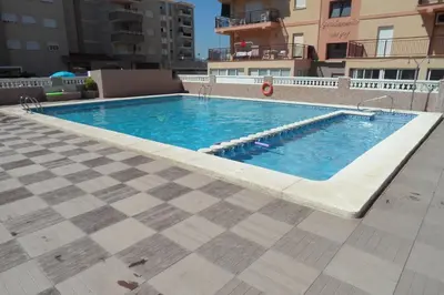 a swimming pool on top of a building at Wimpy Solo Familias Serviplaya in Casas Las Basas