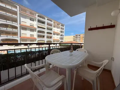 a white table and chairs on a balcony at Wimpy Solo Familias Serviplaya in Casas Las Basas