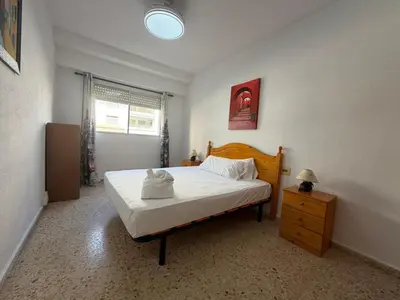 a bedroom with a bed with white sheets on it at Wimpy Solo Familias Serviplaya in Casas Las Basas
