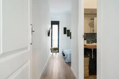 a hallway leading to a kitchen with white walls at Maison avec piscine à Valencia in Valencia