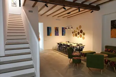 a room with a staircase and a table and chairs at Maison avec piscine à Valencia in Valencia