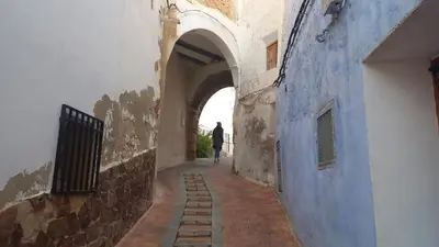 a person walking down an alley in a building at CasaJulis Chelva in Chelva