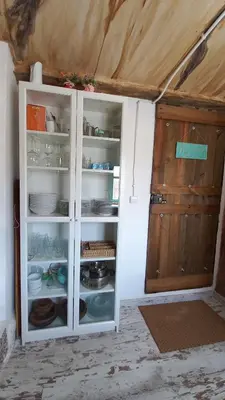 a white cabinet with plates and dishes in it at CasaJulis Chelva in Chelva