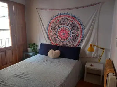 a bedroom with a bed with a teddy bear on it at Casita Mona y Acogedora in Alaquas