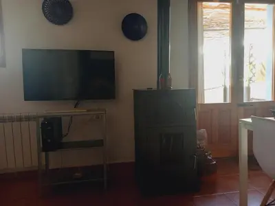a living room with a flat screen tv on the wall at Casita Mona y Acogedora in Alaquas