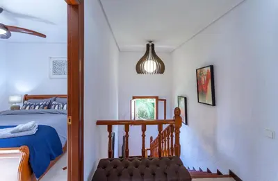 a bedroom with a bed and a pendant light at VILLA LATEL in Serra