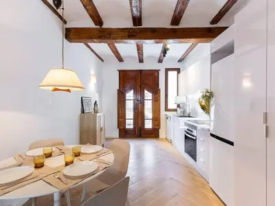 a kitchen and dining room with a table and chairs at Beautiful restored house with terrace in Valencia