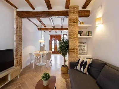 a living room with a couch and a table at Beautiful restored house with terrace in Valencia