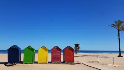 a row of colorful beach huts on the beach at Primera linea - Descanso Sol y Mar in Cullera