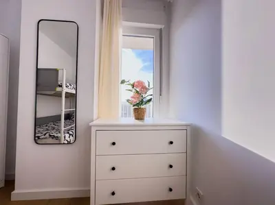 a white dresser with a mirror and a window at Tranquilidad a 2 minutos del mar in Canet de Berenguer