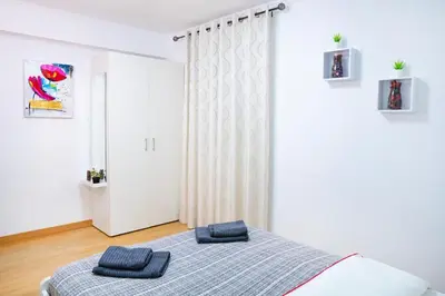 a bedroom with a bed with two blue towels on it at Sollana Arena in Valencia