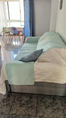 a bed with two pillows on it in a bedroom at Casa Schila in Tavernes de Valldigna