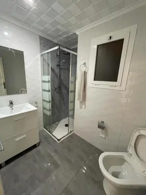 a bathroom with a shower and a toilet and a sink at MALVARROSA BEACH FAMILIAR in Valencia