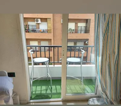 a room with a balcony with two chairs on a balcony at Arts and Sciens Museum/Beach in Valencia