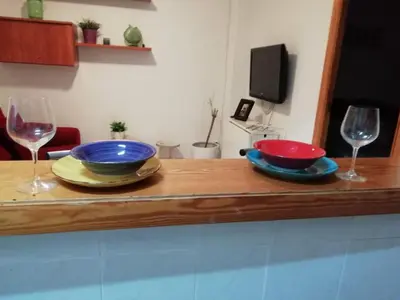 two bowls and wine glasses sitting on a wooden counter at Arts and Sciens Museum/Beach in Valencia