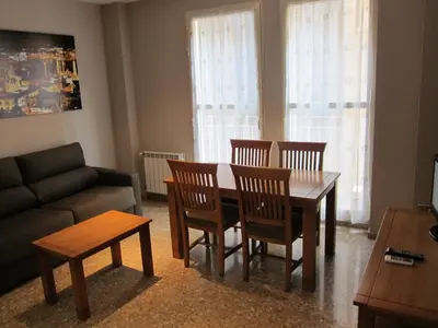 a living room with a table and chairs and a couch at Apartamentos Valencia in Valencia