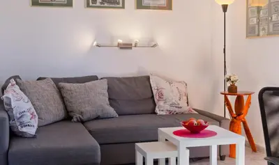 a living room with a gray couch and a table at Casa Catinca Cullera - Beach House On the Dune in Cullera