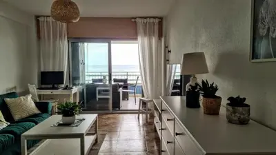 a living room with a couch and a living room with a view at Apartmán pri mori in El Brosquil