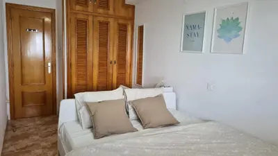a white bed with two pillows on it in a room at Apartmán pri mori in El Brosquil