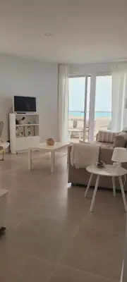 a living room with a couch and a table at Apartamento con vistas en Gran Canet in Canet de Berenguer
