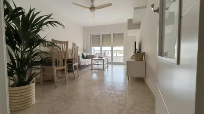 a living room with a table and a potted plant at LA CULLERINA playa San Antonio con Internet Alta Velocidad Aire Acondicionado in Cullera