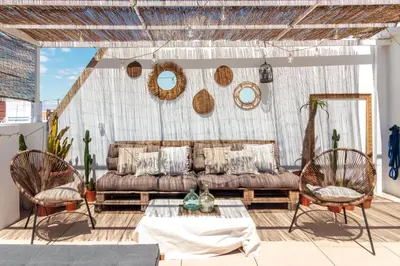 a living room with a couch and two chairs at Precioso ático en Valencia. in Valencia