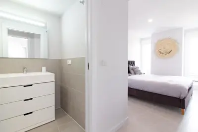 a white bathroom with a bed and a sink at Global Vacacional, Apartamento de 2 habitaciones con gran terraza en Gran Canet in Canet de Berenguer