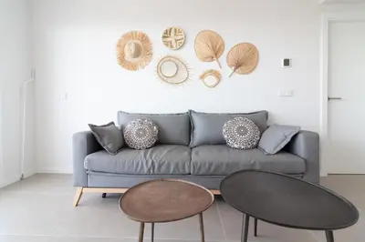 a living room with a couch and two tables at Global Vacacional, Apartamento de 2 habitaciones con gran terraza en Gran Canet in Canet de Berenguer