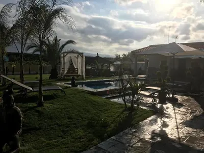 a backyard with a swimming pool and a house at Villas de descanso in Vilamarxant