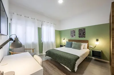 a bathroom with a shower and a toilet and a sink at AmazINN Places Valencia Cabanyal in Valencia