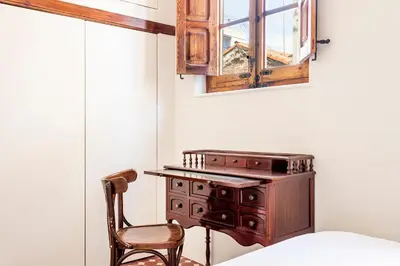 a wooden desk and a chair in a room at Casa Rosario Cabanyal flat near the beach, high end in Valencia