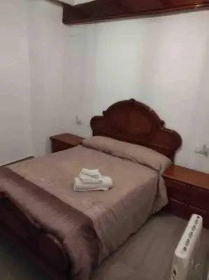 a bed with two white towels on top of it at Casa Coletor in Chulilla