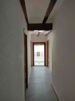 an empty hallway with a hallway leading to a door at Casa Coletor in Chulilla