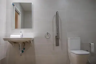 a bathroom with a sink and a toilet and a mirror at Cid 90 Flat by Concept in Valencia