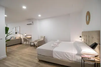 a bedroom with a bed and a table and chairs at Cid Flats by Concept in Valencia
