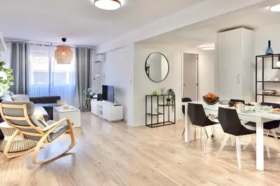 a living room with a table and chairs and a dining room at SPACIOUS, SUNNY FLAT BY CITY OF ARTS & SCIENCES in Valencia