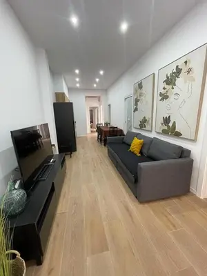 a living room with a couch and a flat screen tv at UIM Mediterraneo CASA Virgen de los Dolores Wifi in Puerto de Sagunto