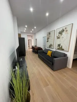 a living room with a couch and a tv at UIM Mediterraneo CASA Virgen de los Dolores Wifi in Puerto de Sagunto