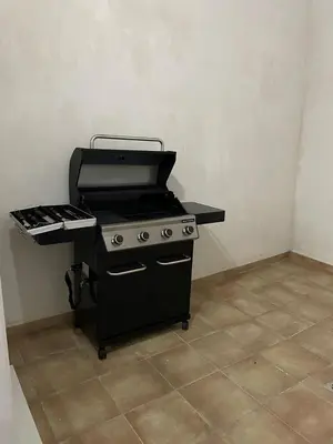 a black stove in a room with a counter at UIM Mediterraneo CASA Virgen de los Dolores Wifi in Puerto de Sagunto