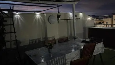 a room with a table and chairs on a balcony at PLAYA ALMENARA ATICO DUPLEX VISTAS AL MAR Y MONTAÑA WIFI,PISCINA a in Almenara