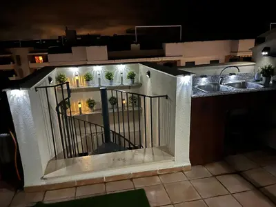 a kitchen with a balcony with a sink and a sink at PLAYA ALMENARA ATICO DUPLEX VISTAS AL MAR Y MONTAÑA WIFI,PISCINA a in Almenara