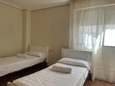 a bedroom with two beds and a window at Borriana Bonica in Burriana