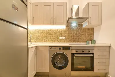 a kitchen with a washing machine and a washer at Apartamento Teo in Russafa in Valencia