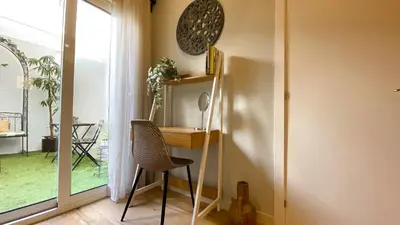 a desk with a chair in a room with a window at Apartamento Teo in Russafa in Valencia