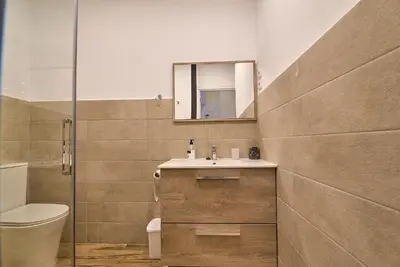 a bathroom with a sink and a toilet and a mirror at Apartamento Teo in Russafa in Valencia