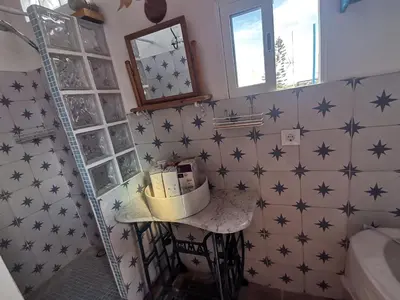 a bathroom with blue stars on the wall at veronica in Llaurí