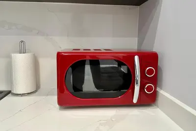 a red microwave sitting on top of a counter at Reinapart Patacona Beach 36 in Valencia